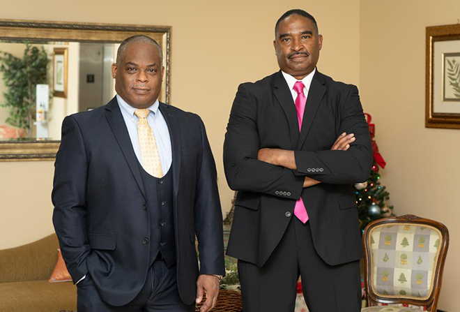 Two men in suits pictured in an office