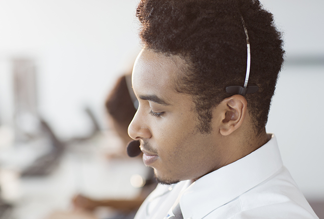Young man wearing headset to answer phones