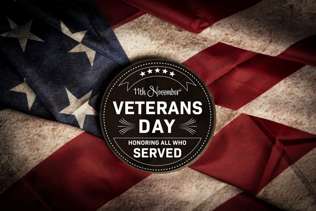 11th november veterans day metal badge on old usa flag in the background